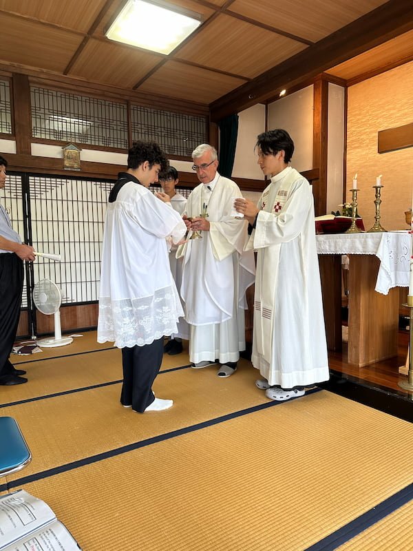A young man receiving the Eucharist in Takeo Catholic Church