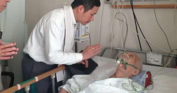 A priest visiting the sick and praying by his bedside
