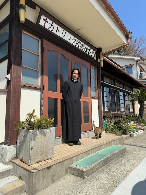 Picture of Father Johannes in front of Takeo Catholic Church door
